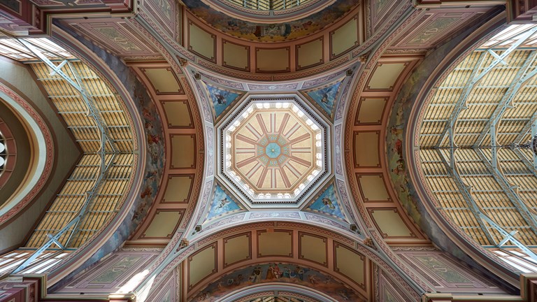 A view of a decorative ceiling from below looking up