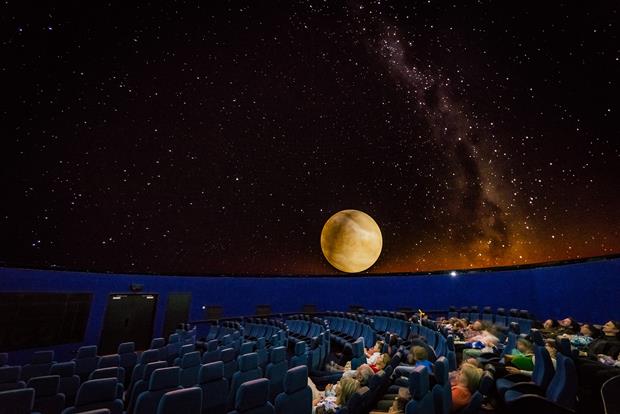 People viewing a show in the planetarium